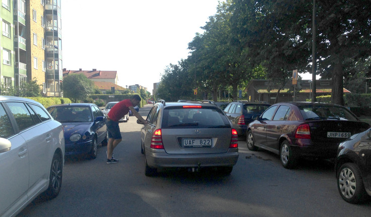 Typical local street in Malmo, Sweden. The narrowness of the streets ensures cars travel at a slow speed, allowing for other activity such as social interaction, to take place safely.