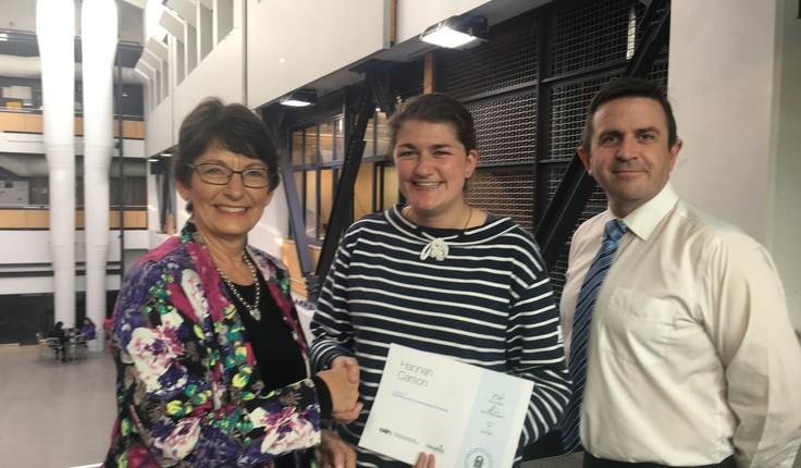 Marilyn Best from Megabits and Michael Wright (NZILA Wellington Branch Secretary) present Hannah Carson with her award.