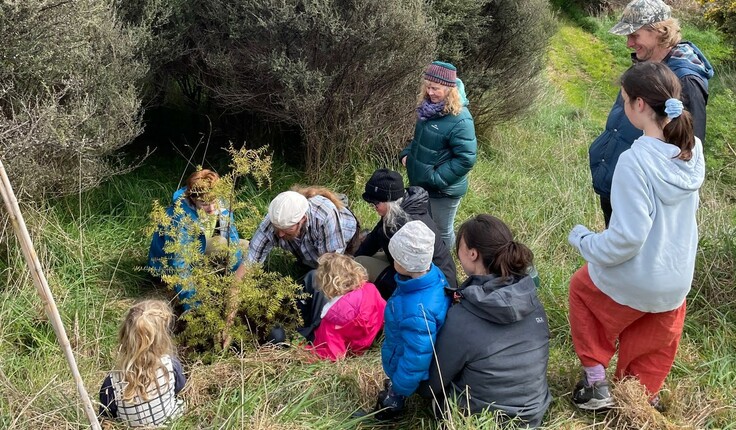 John Wraight and Nicole Thompson with family members plant a totara for Megan.