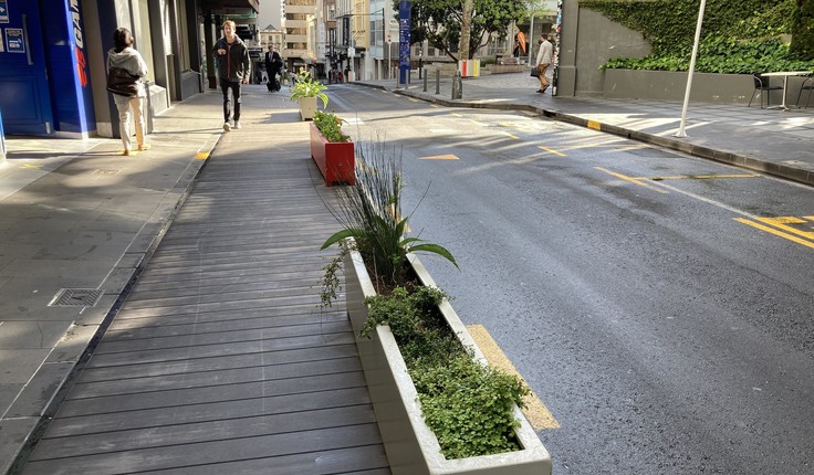 High St uses planter boxes and wide footpaths.
