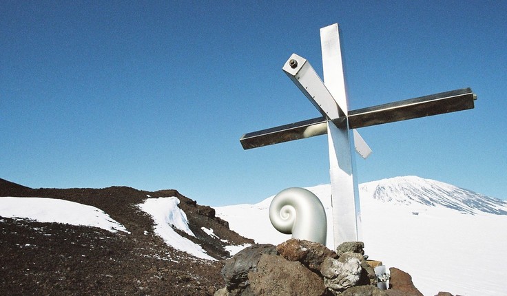 Koru capsule and cross on Mt Erebus. The cross is located approximately 3 km south-east of the 1979 crash site. This stainless steel cross was erected in 1987 to replace the original wooden one, which had eroded. The Koru was created by Christchurch sculptor, Phil Price. Photo credit: Daniel O’Sullivan, 2009-10, Antarctica New Zealand Pictorial Collection.