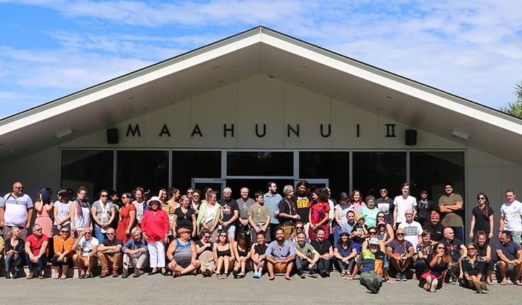 (Manuhiri ki Mahaanui II) – Attendees gathering under the mahau of Maahunui II at Tuahiwi Marae;