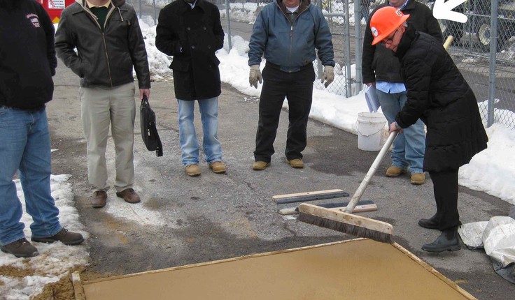 Julie Bargmann - yes that’s her under the big arrow - demonstrates the “crazy broom” finish technique on a concrete mock-up.