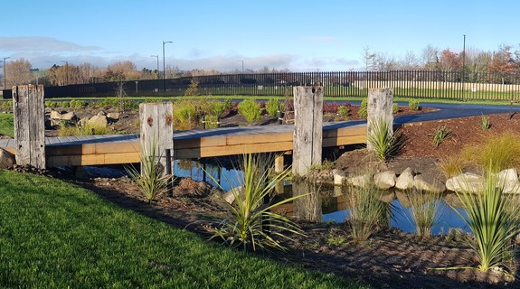 Timber bridges allow contact with the water, and good circulation for cyclists or joggers. The bridges are flanked by historic salvaged wharf beams, sourced from Lyttelton Port