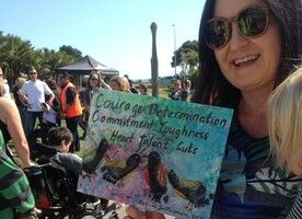 Martha shows off some of Falcon’s artwork while attending the Taranaki Hikoi for New Zealanders with disabilities.