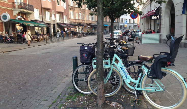 Locals using the shared street berm for cycle parking in Malmo, Sweden
