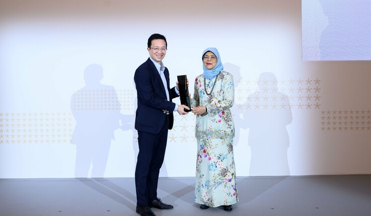 Leonard receiving his President's Award award from Halimah Yacob, 8th President of Singapore