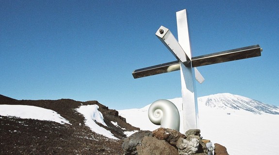 Koru capsule and cross on Mt Erebus. The cross is located approximately 3 km south-east of the 1979 crash site. This stainless steel cross was erected in 1987 to replace the original wooden one, which had eroded. The Koru was created by Christchurch sculptor, Phil Price. Photo credit: Daniel O’Sullivan, 2009-10, Antarctica New Zealand Pictorial Collection.