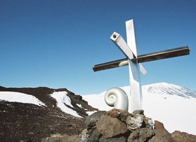 Koru capsule and cross on Mt Erebus. The cross is located approximately 3 km south-east of the 1979 crash site. This stainless steel cross was erected in 1987 to replace the original wooden one, which had eroded. The Koru was created by Christchurch sculptor, Phil Price. Photo credit: Daniel O’Sullivan, 2009-10, Antarctica New Zealand Pictorial Collection.